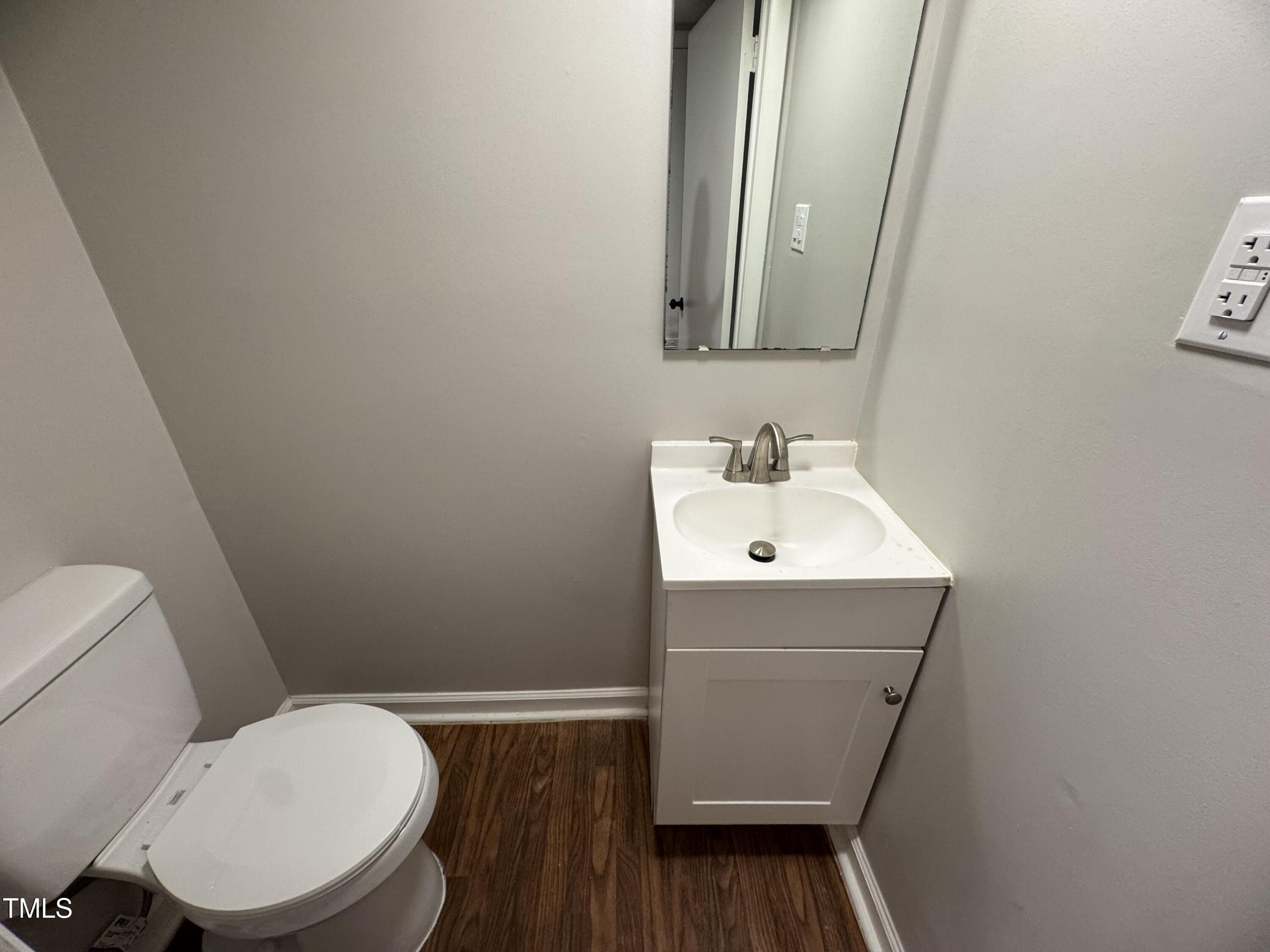 1222 Teakwood Place Raleigh, NC 27606 - Photo 6 of 15 a bathroom with a sink toilet and mirror