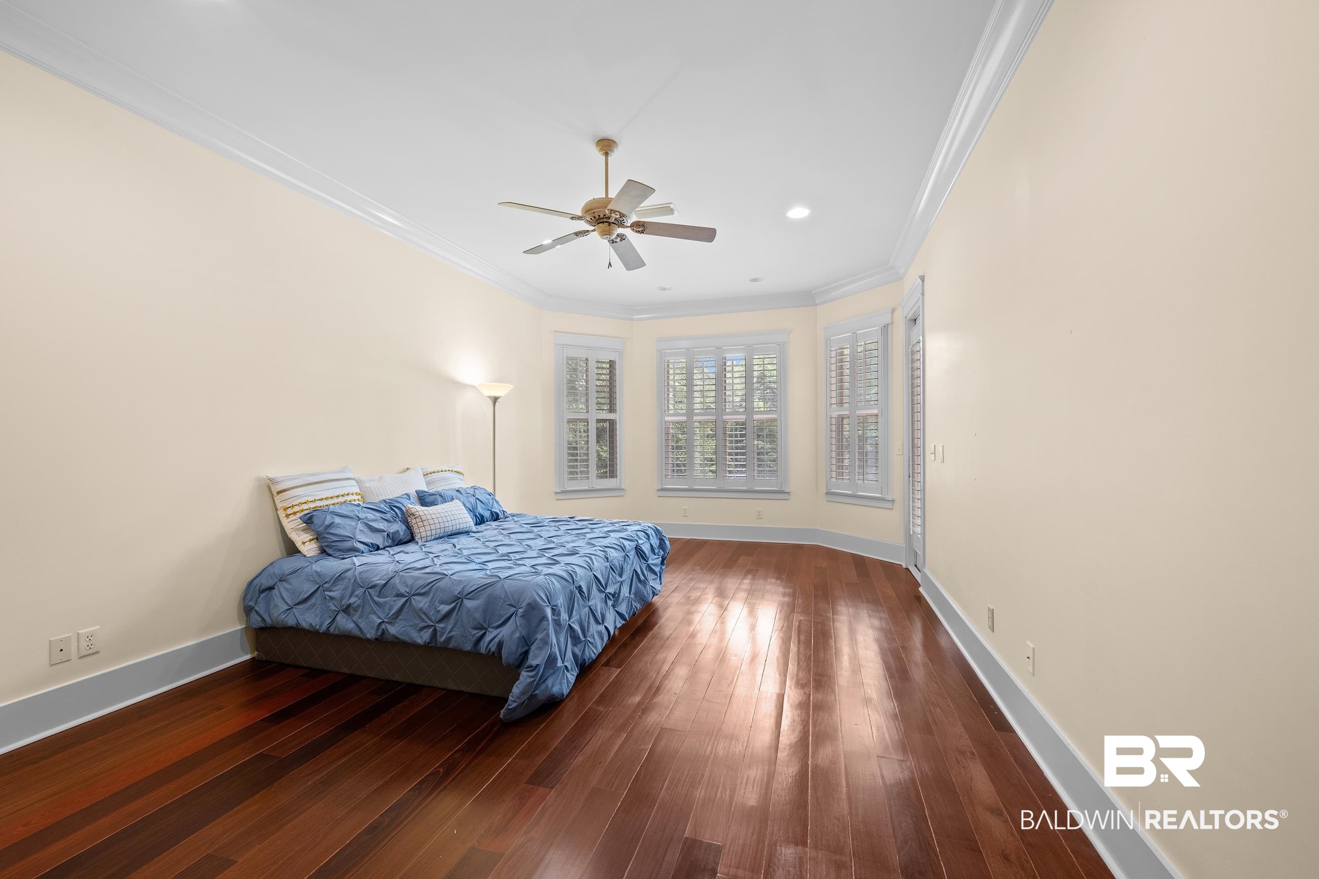30463 Dolive Ridge Daphne, AL 36527 - Photo 45 of 58 Spacious room featuring wood-finish flooring, light-colored walls, and crown molding