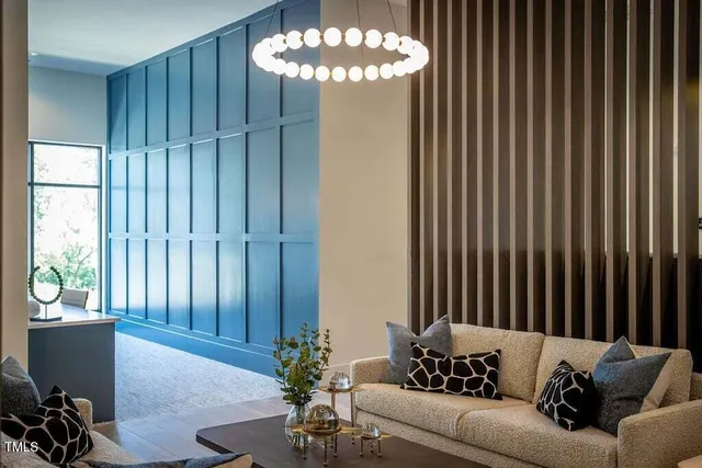 a living room with furniture and a chandelier