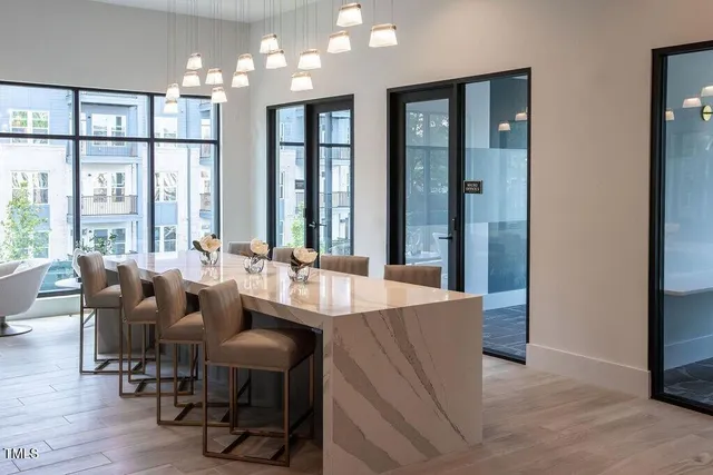 a dining room with furniture and wooden floor