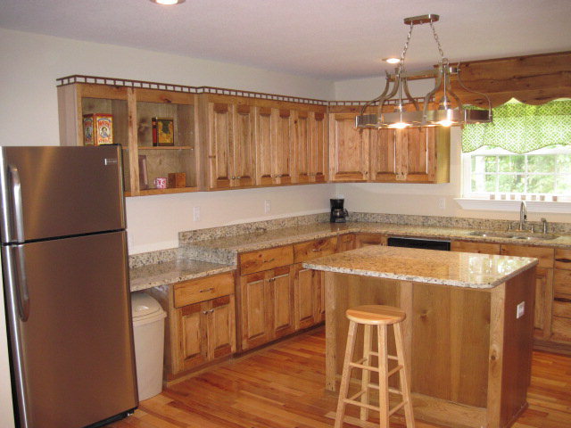 117 Jenkins Road Forsyth, GA 31029 - Photo 6 of 18 a kitchen with stainless steel appliances granite countertop a refrigerator a sink dishwasher a stove with wooden cabinets and floor