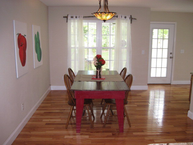 117 Jenkins Road Forsyth, GA 31029 - Photo 8 of 18 a view of a dining room with furniture a chandelier and wooden floor