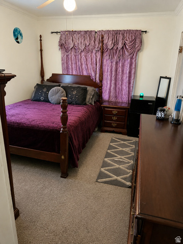 1225 South Main Street Mapleton, UT 84664 - Photo 19 of 21 Carpeted bedroom featuring a ceiling fan with integrated lighting, crown molding, and a window with valance and drapery