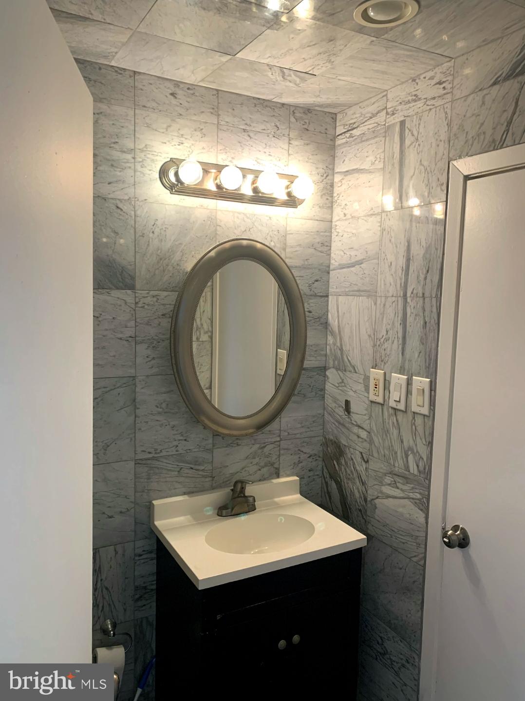9358 Neil Road, Unit A Philadelphia, PA 19115 - Photo 12 of 24 a bathroom with a sink and a mirror
