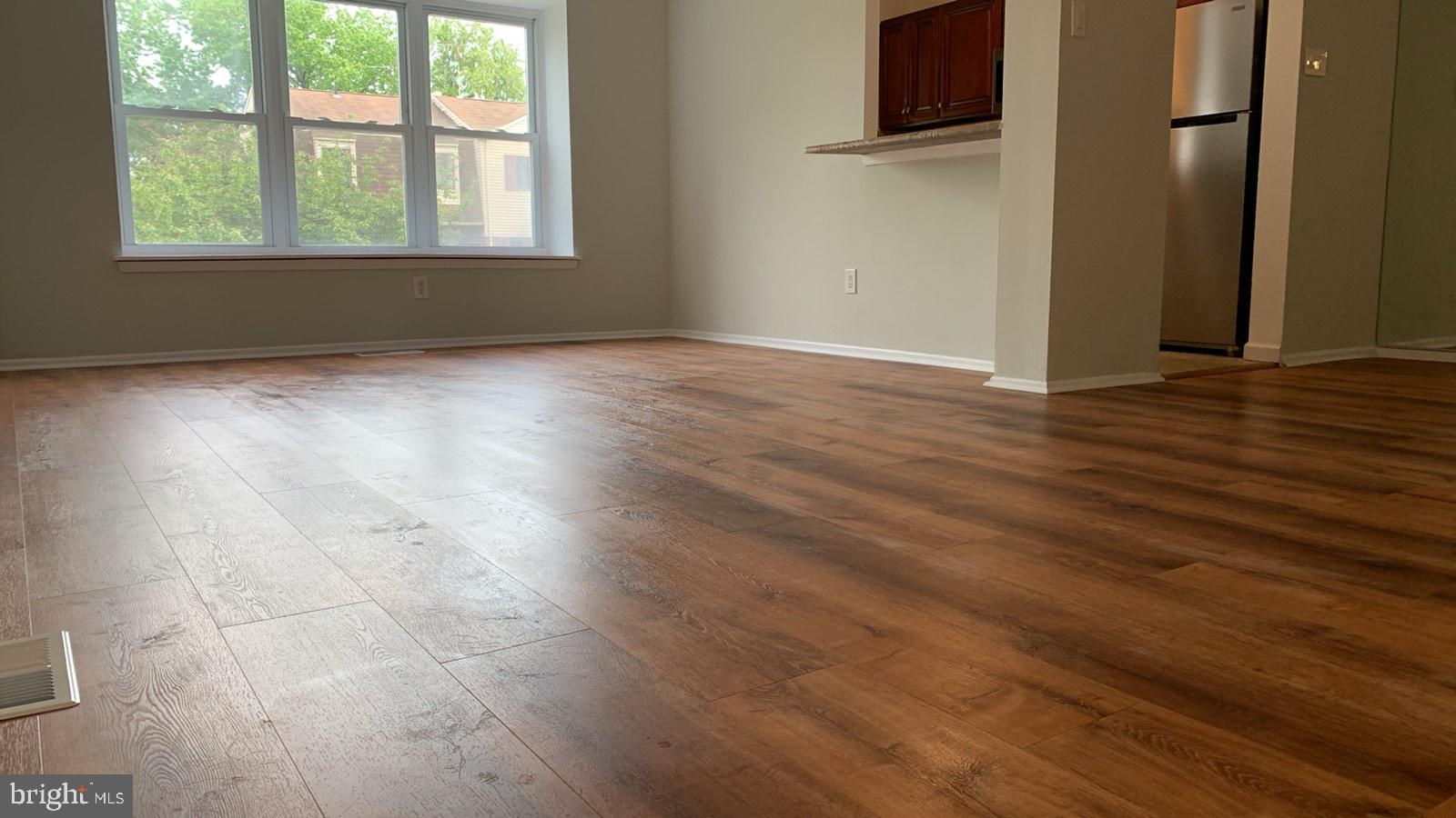 9358 Neil Road, Unit A Philadelphia, PA 19115 - Photo 18 of 24 an empty room with wooden floor and windows
