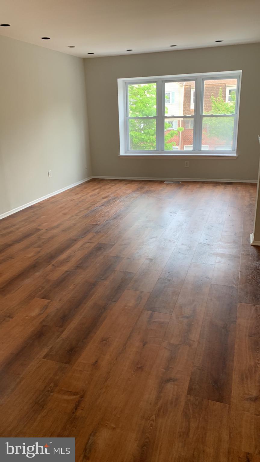 9358 Neil Road, Unit A Philadelphia, PA 19115 - Photo 20 of 24 an empty room with wooden floor and windows