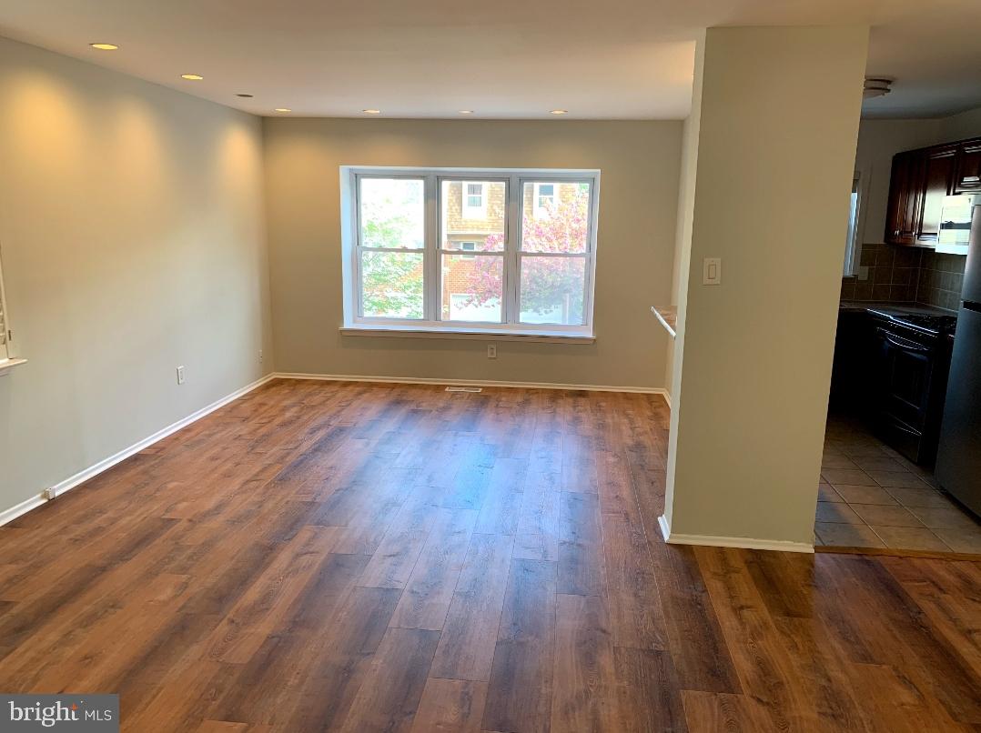 9358 Neil Road, Unit A Philadelphia, PA 19115 - Photo 4 of 24 an empty room with wooden floor and windows