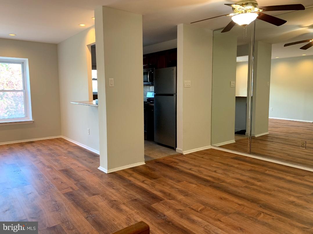 9358 Neil Road, Unit A Philadelphia, PA 19115 - Photo 5 of 24 an empty room with wooden floor and chandelier fan