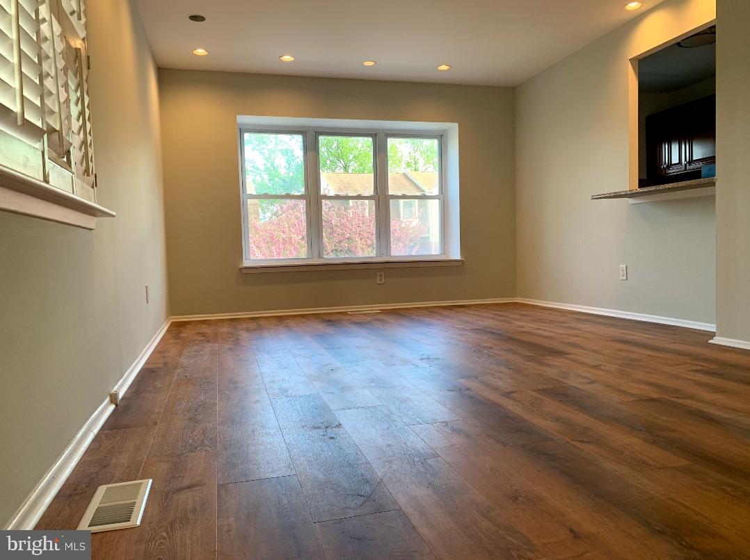 9358 Neil Road, Unit A Philadelphia, PA 19115 - Photo 6 of 24 a view of empty room with wooden floor and fan