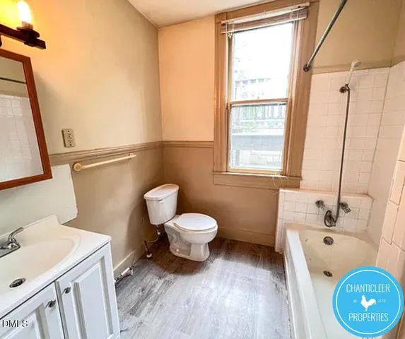 a bathroom with a sink a toilet and a tub