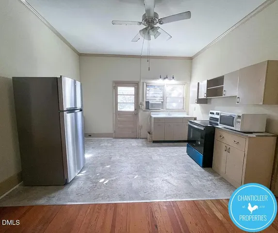 a kitchen with stainless steel appliances granite countertop a refrigerator a sink dishwasher a stove with wooden cabinets and floor