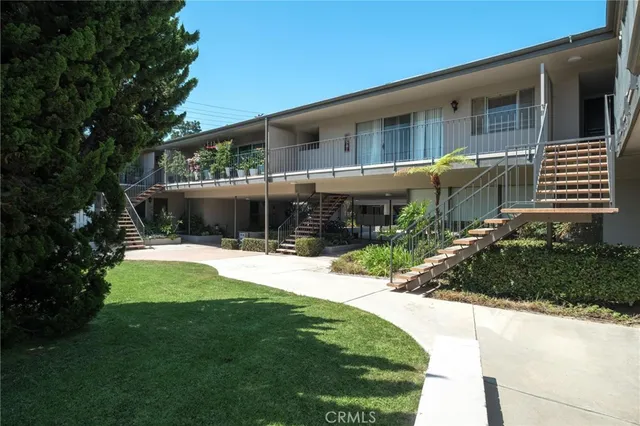 a view of a house with a small yard and plants
