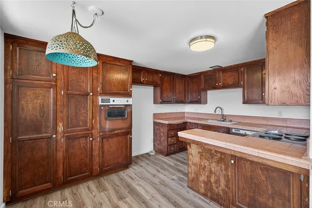 a kitchen with stainless steel appliances granite countertop a sink a stove a refrigerator and cabinets