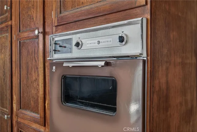a kitchen with a stove and a wooden floor