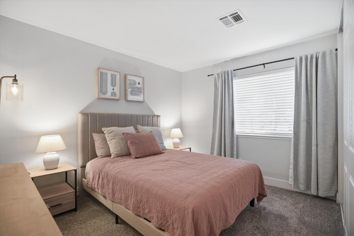 3424 Vintage Drive, Unit 152 Modesto, CA 95356 - Photo 14 of 24 a bedroom with a bed and a night lamp