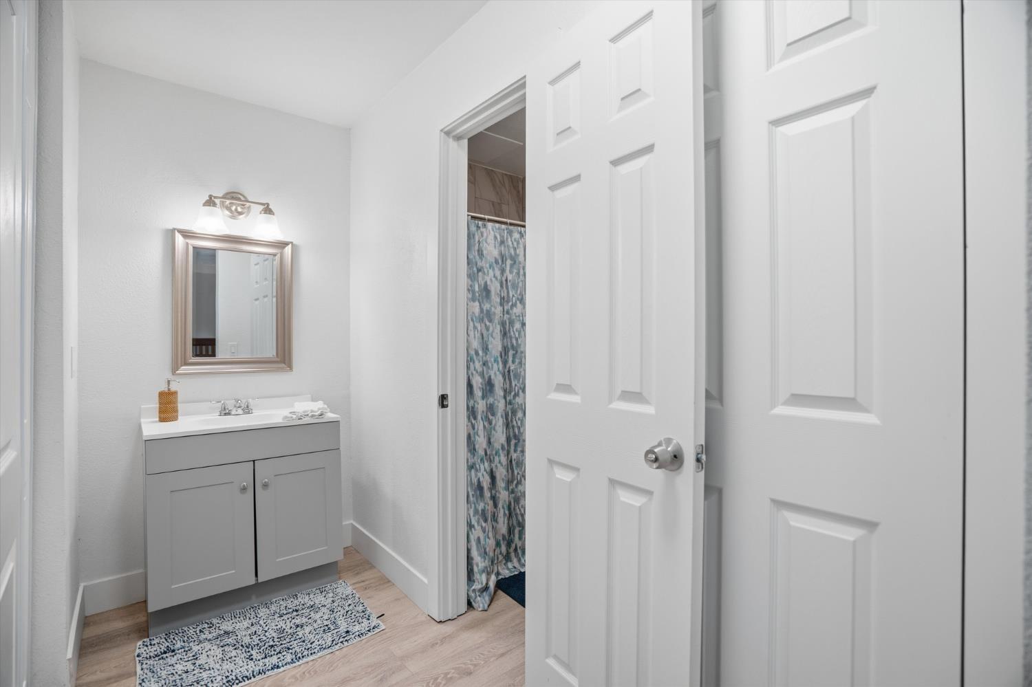 3424 Vintage Drive, Unit 152 Modesto, CA 95356 - Photo 17 of 24 a bathroom with a double vanity sink and mirror with shower