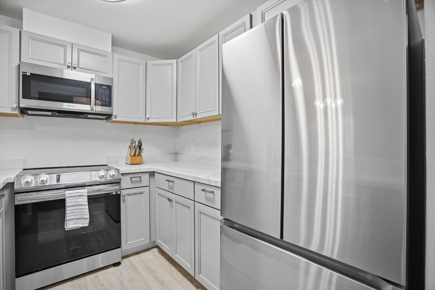 3424 Vintage Drive, Unit 152 Modesto, CA 95356 - Photo 8 of 24 a kitchen with white cabinets and stainless steel appliances