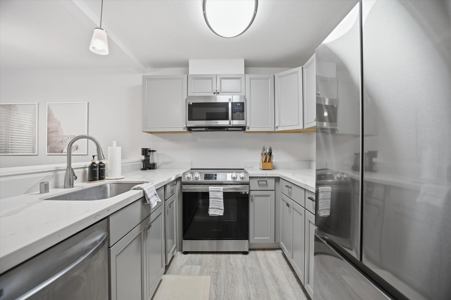 3424 Vintage Drive, Unit 152 Modesto, CA 95356 - Photo 10 of 24 a kitchen with stainless steel appliances granite countertop a sink stove a refrigerator and cabinets