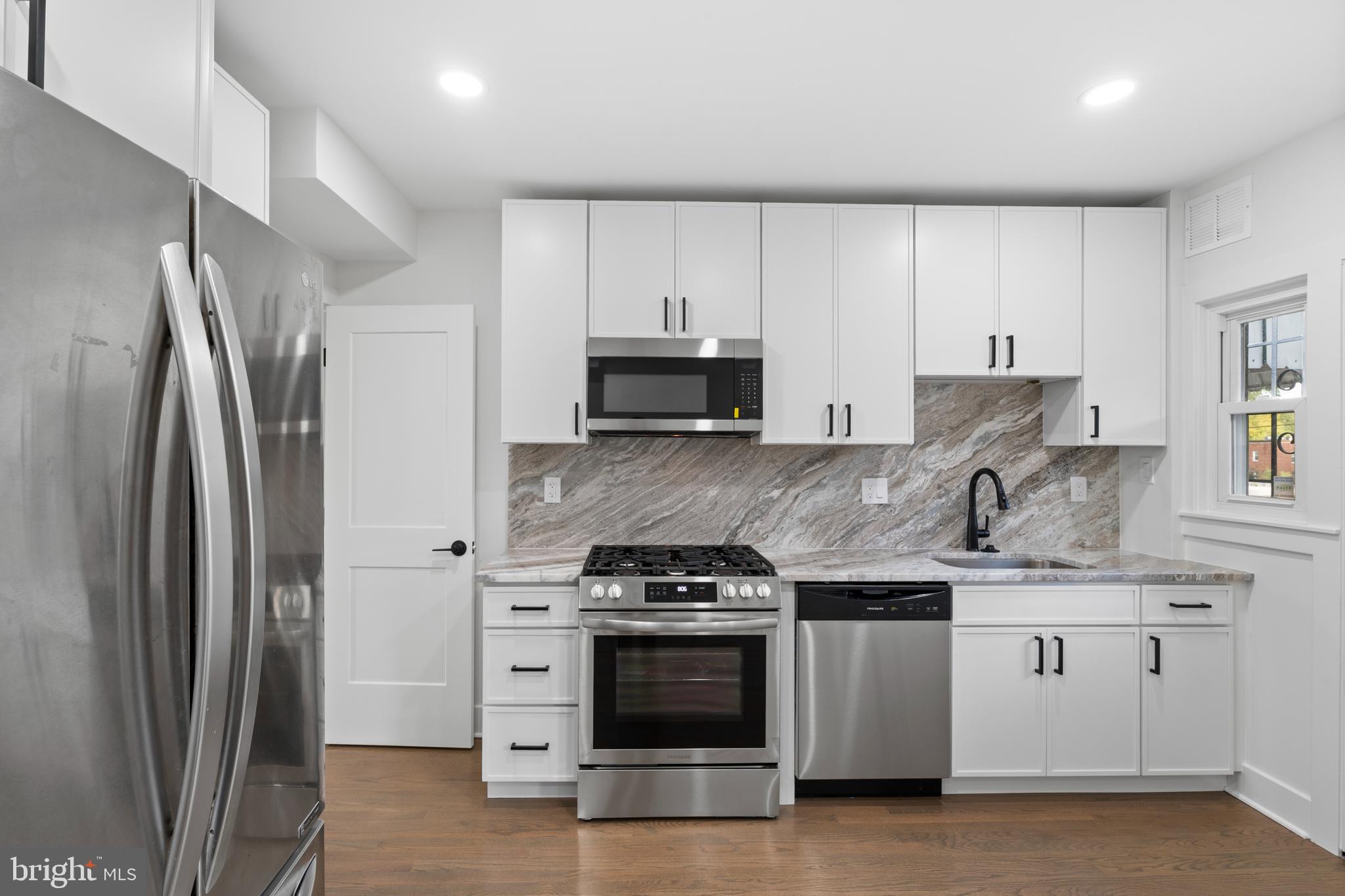 38 Crittenden Street Northeast Washington, DC 20011 - Photo 10 of 48 a kitchen with stainless steel appliances granite countertop a refrigerator stove and sink