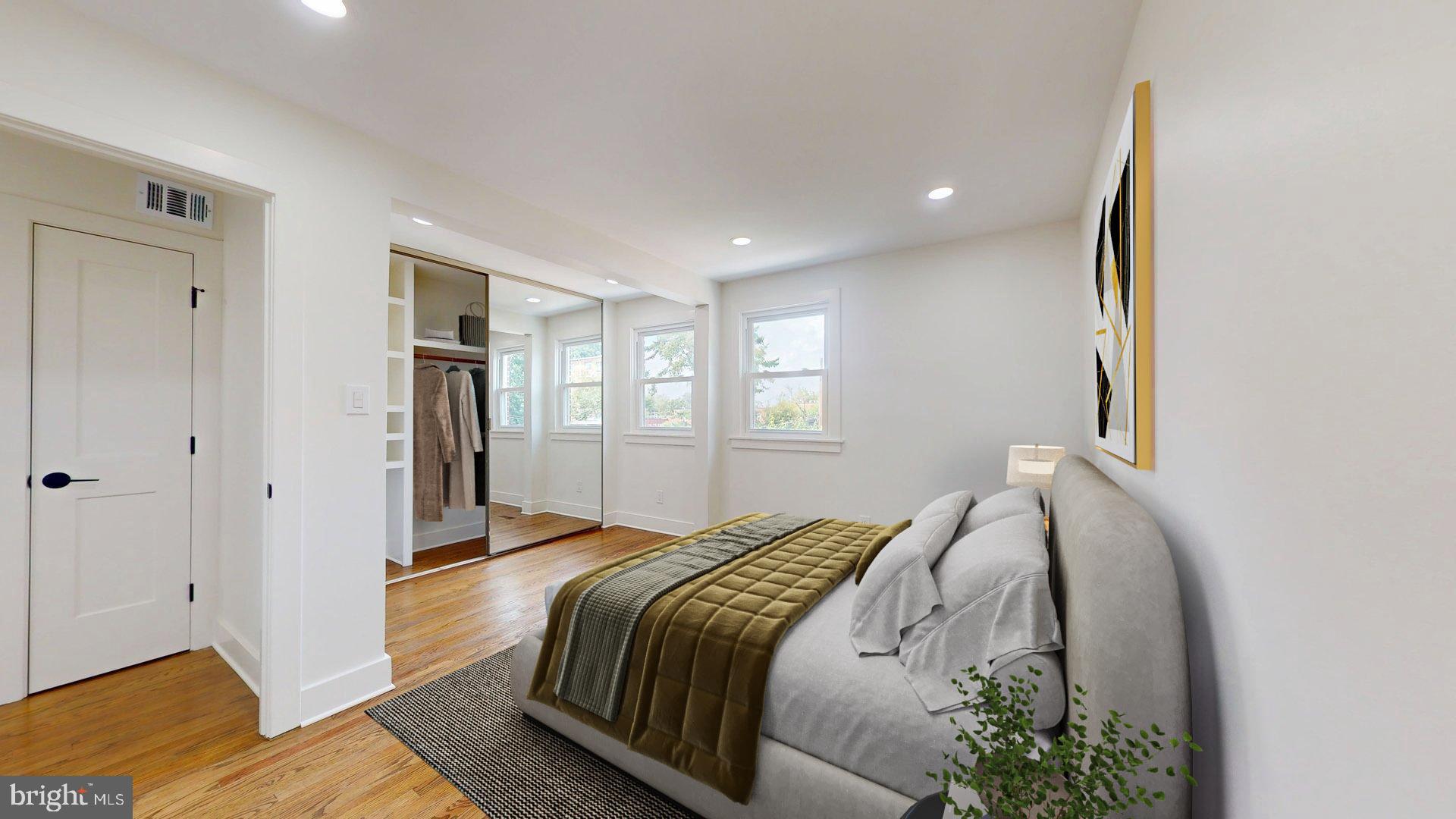 38 Crittenden Street Northeast Washington, DC 20011 - Photo 16 of 48 a spacious bedroom with a bed and a chandelier