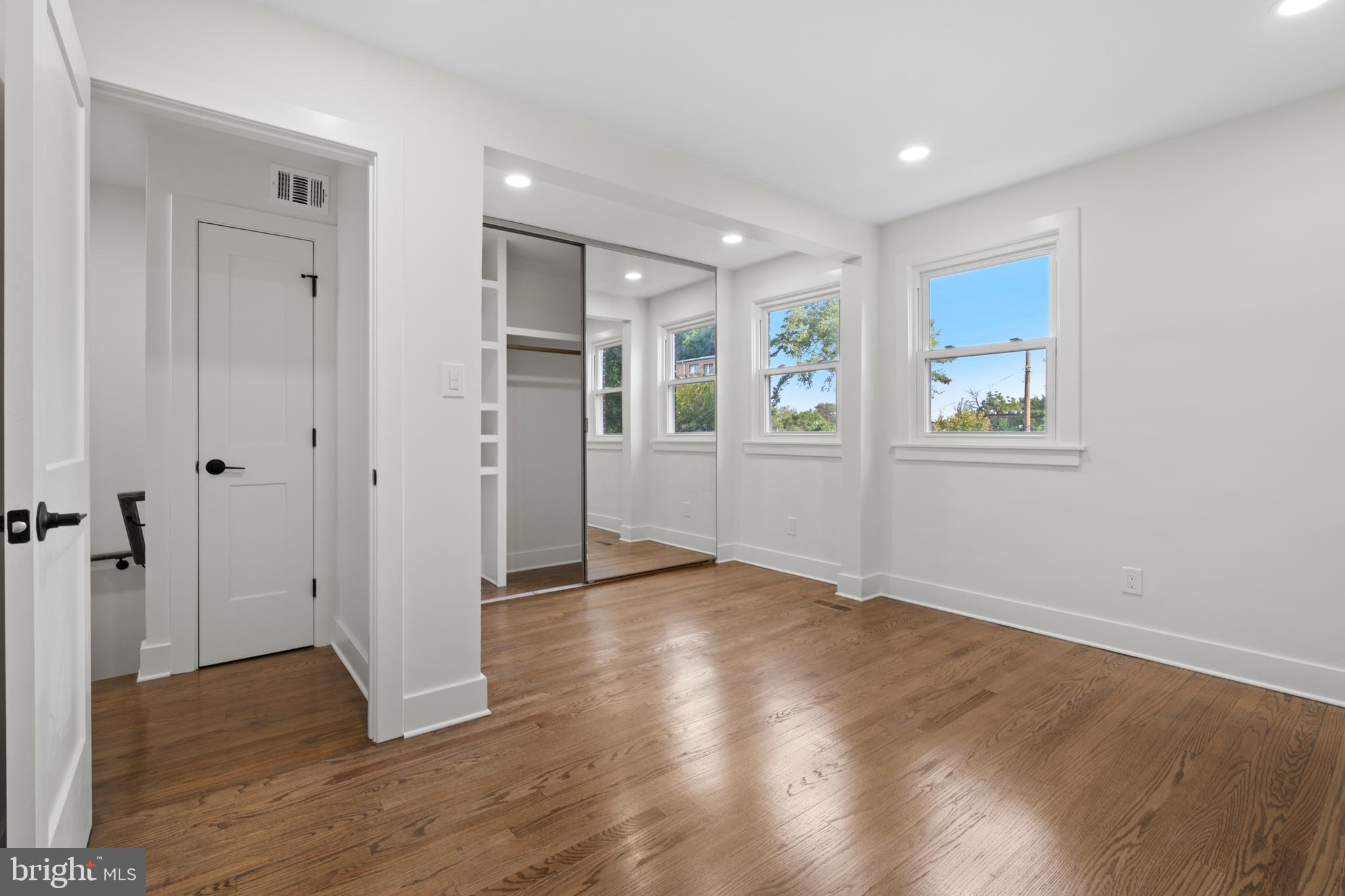 38 Crittenden Street Northeast Washington, DC 20011 - Photo 18 of 48 an empty room with wooden floor and windows
