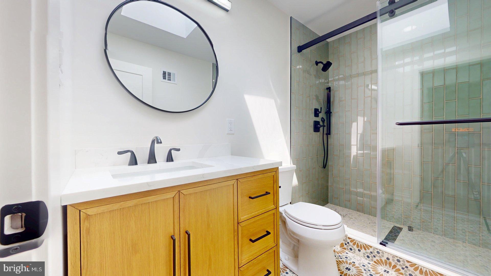 38 Crittenden Street Northeast Washington, DC 20011 - Photo 21 of 48 a bathroom with a sink a toilet and a mirror
