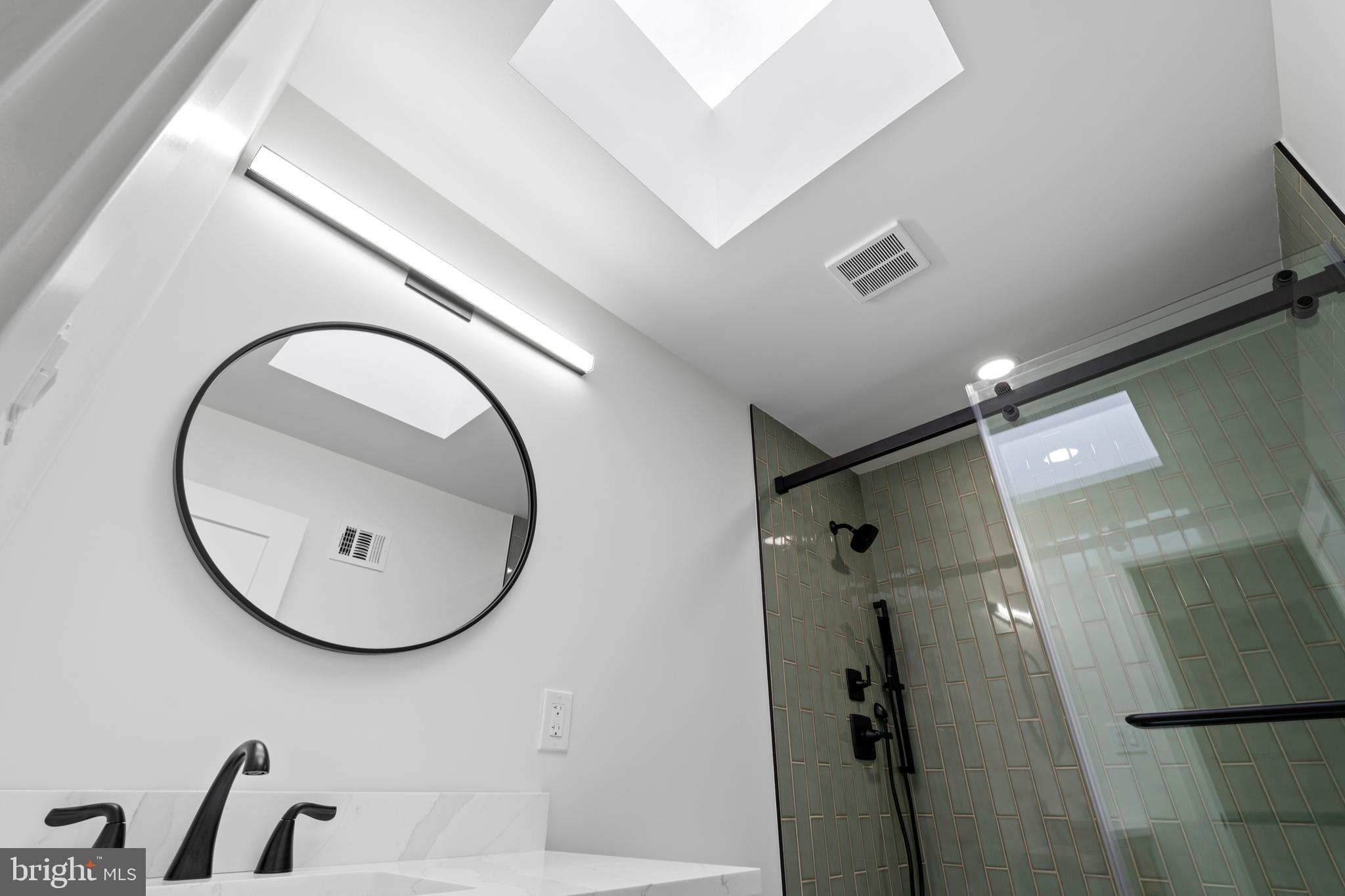 38 Crittenden Street Northeast Washington, DC 20011 - Photo 23 of 48 a bathroom with a mirror a sink and a mirror