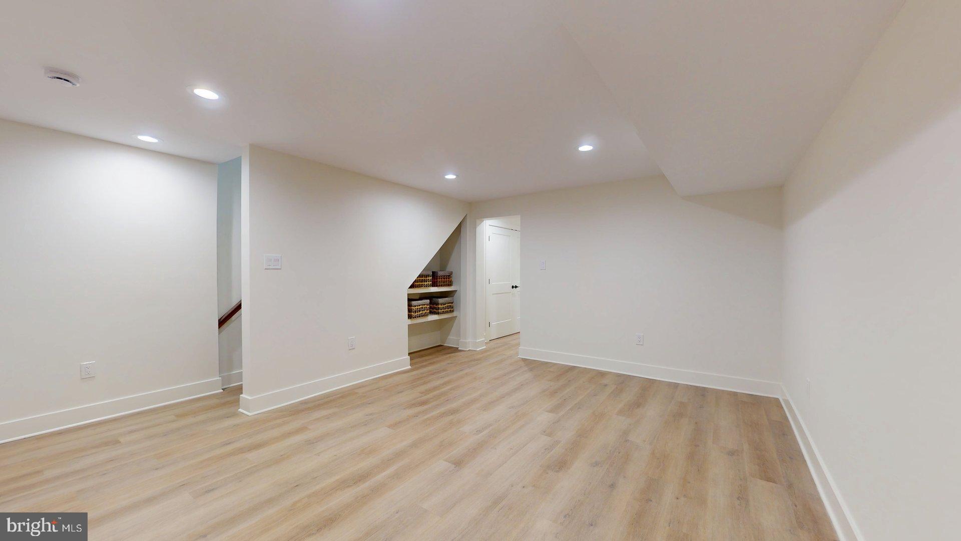 38 Crittenden Street Northeast Washington, DC 20011 - Photo 48 of 48 an empty room with wooden floor and white walls