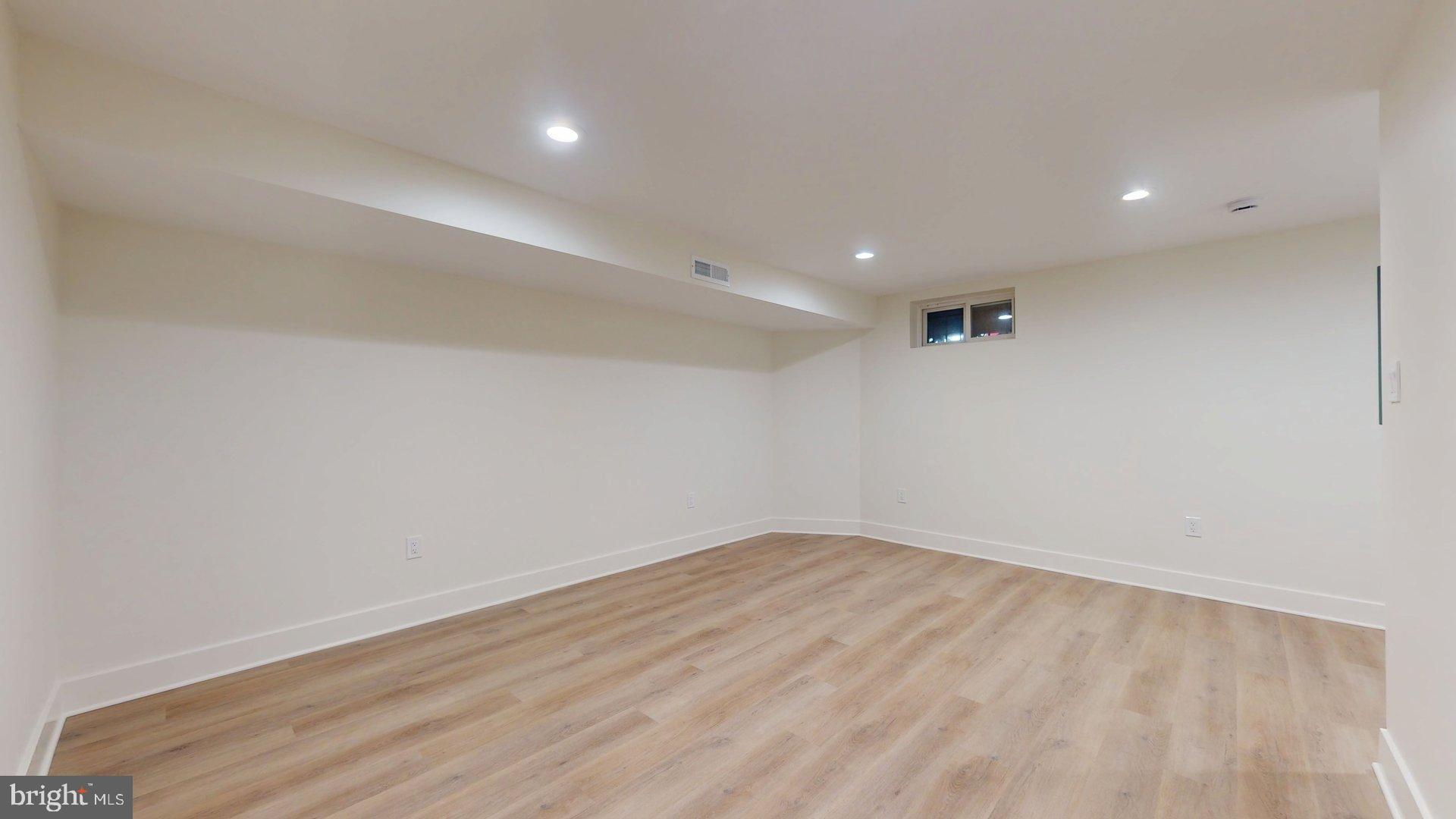 38 Crittenden Street Northeast Washington, DC 20011 - Photo 32 of 48 an empty room with wooden floor and windows