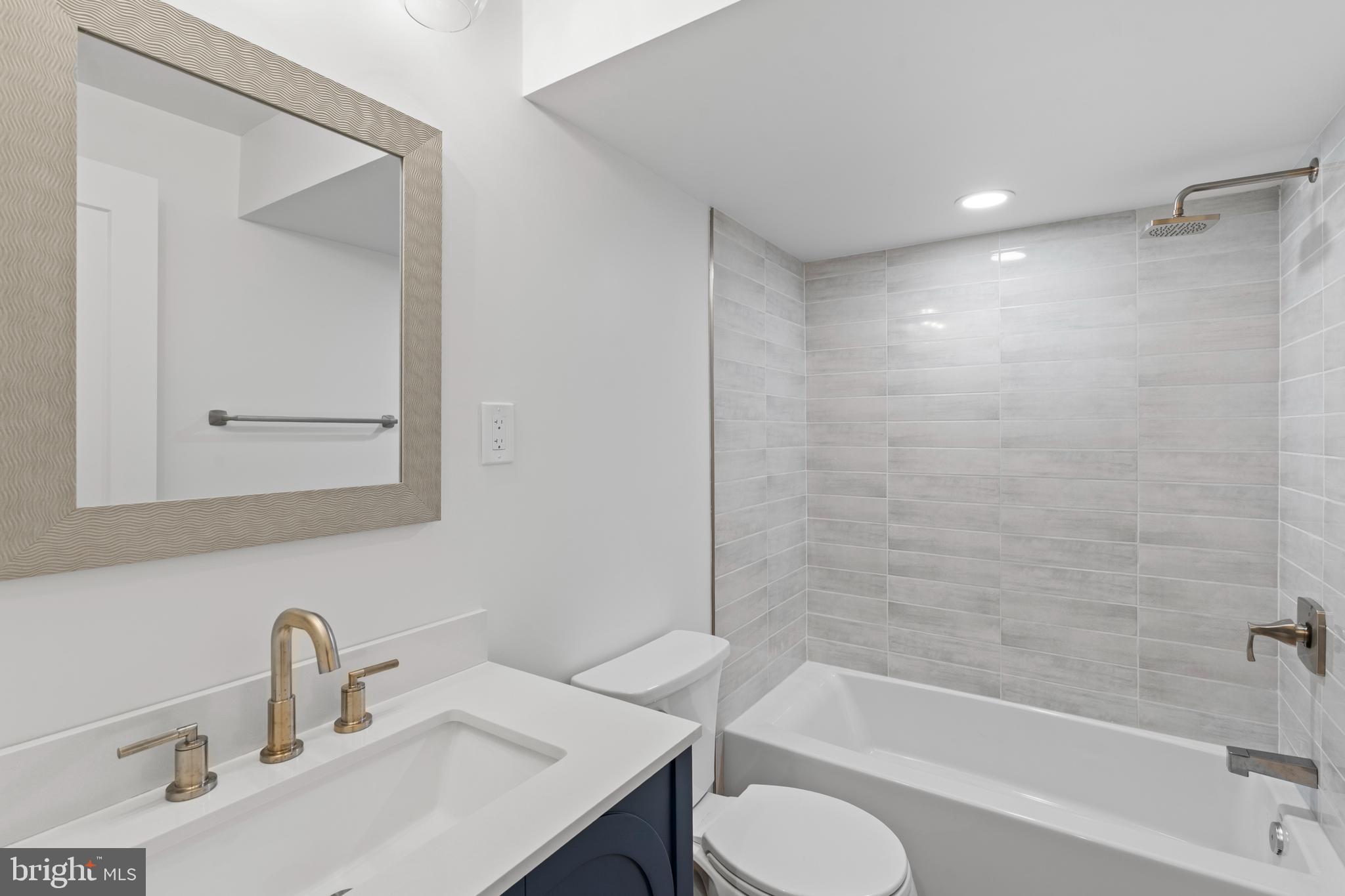 38 Crittenden Street Northeast Washington, DC 20011 - Photo 35 of 48 a bathroom with a sink toilet a mirror and shower