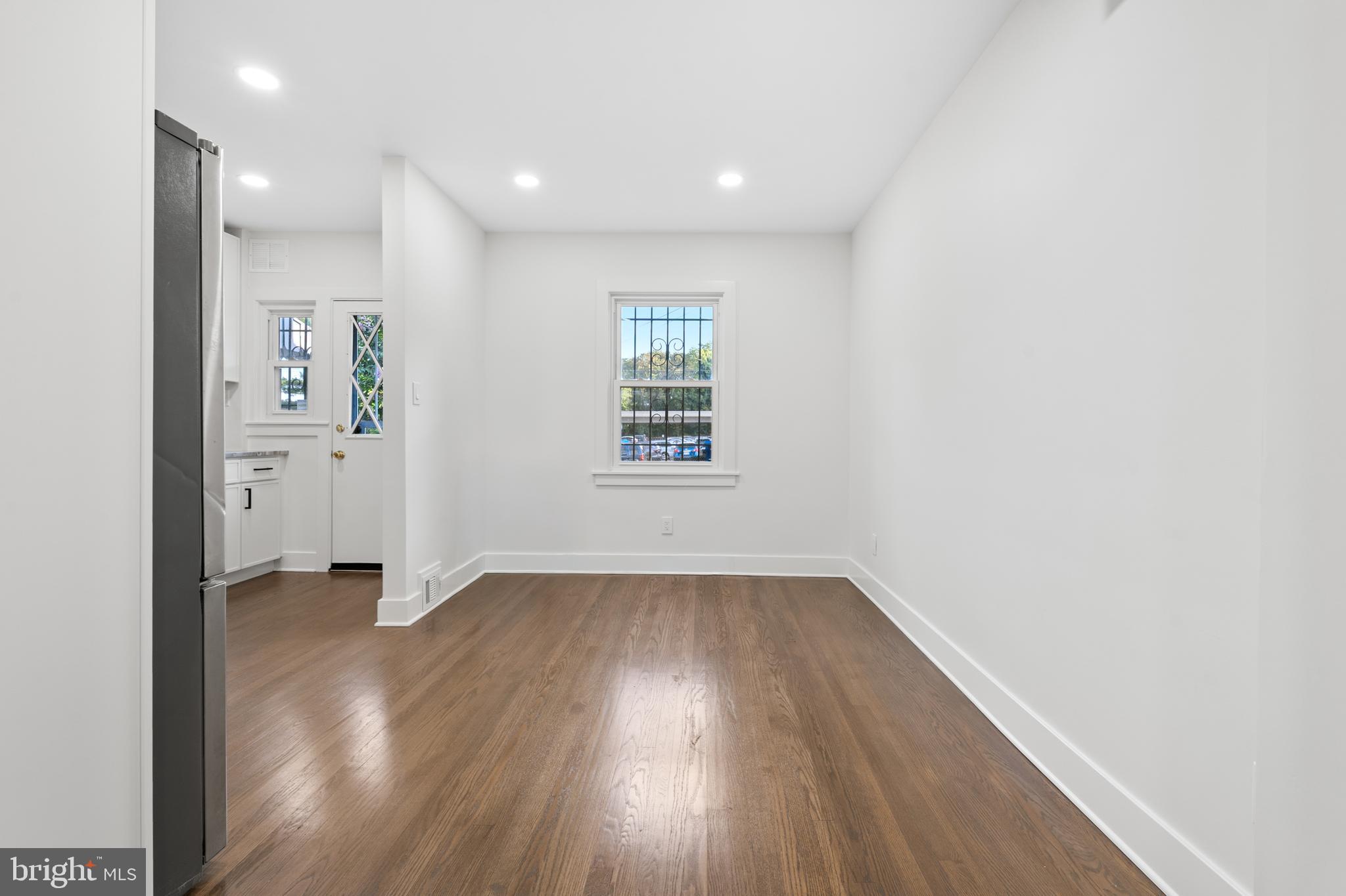 38 Crittenden Street Northeast Washington, DC 20011 - Photo 8 of 48 an empty room with wooden floor and windows
