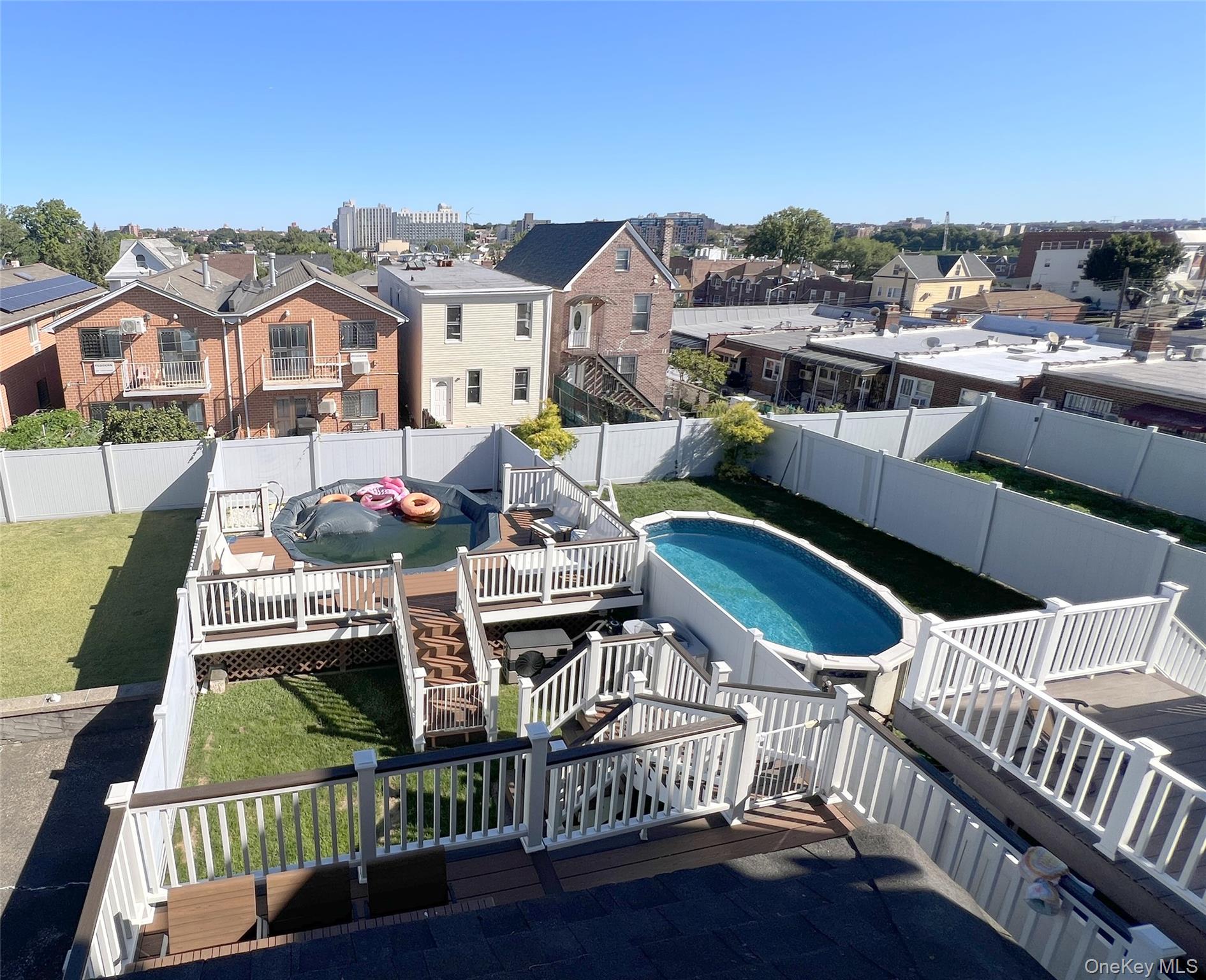 67-31 52nd Road Queens, NY 11378 - Photo 19 of 21 View of pool featuring a deck, a fenced backyard, and a residential view