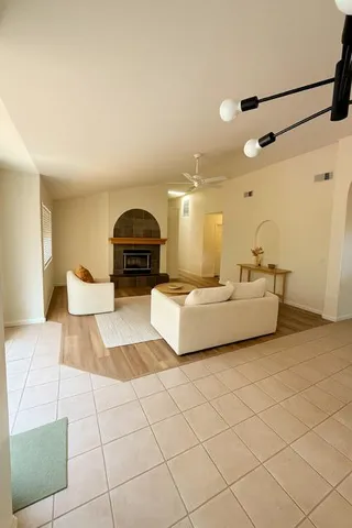 a living room with furniture and a chandelier