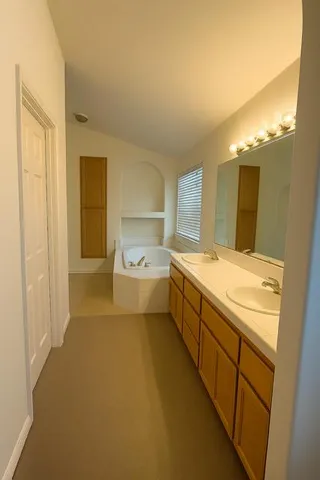 a large bathroom with a sink a large mirror and a bathtub
