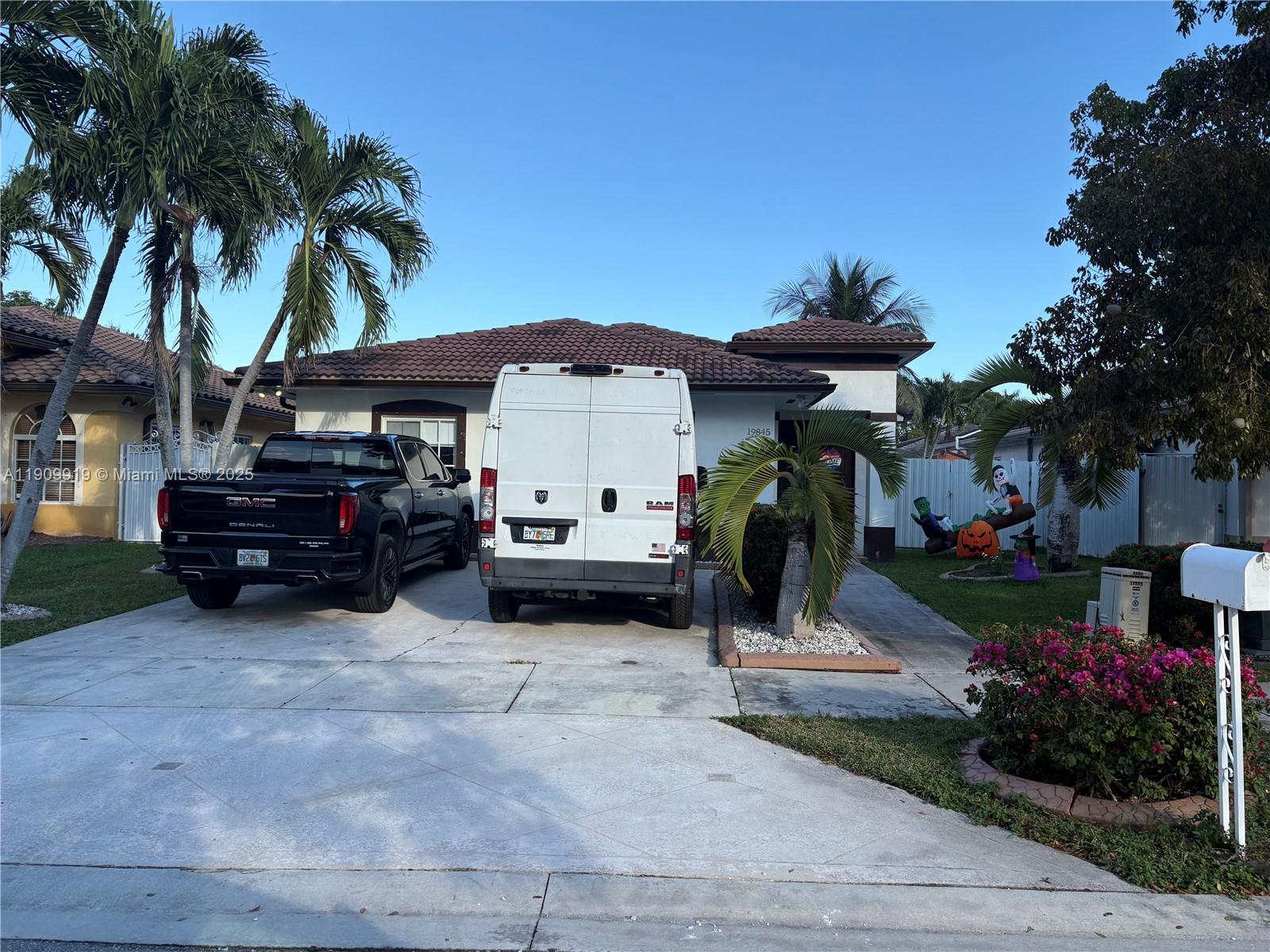a view of a chairs and tables in the back yard of the house