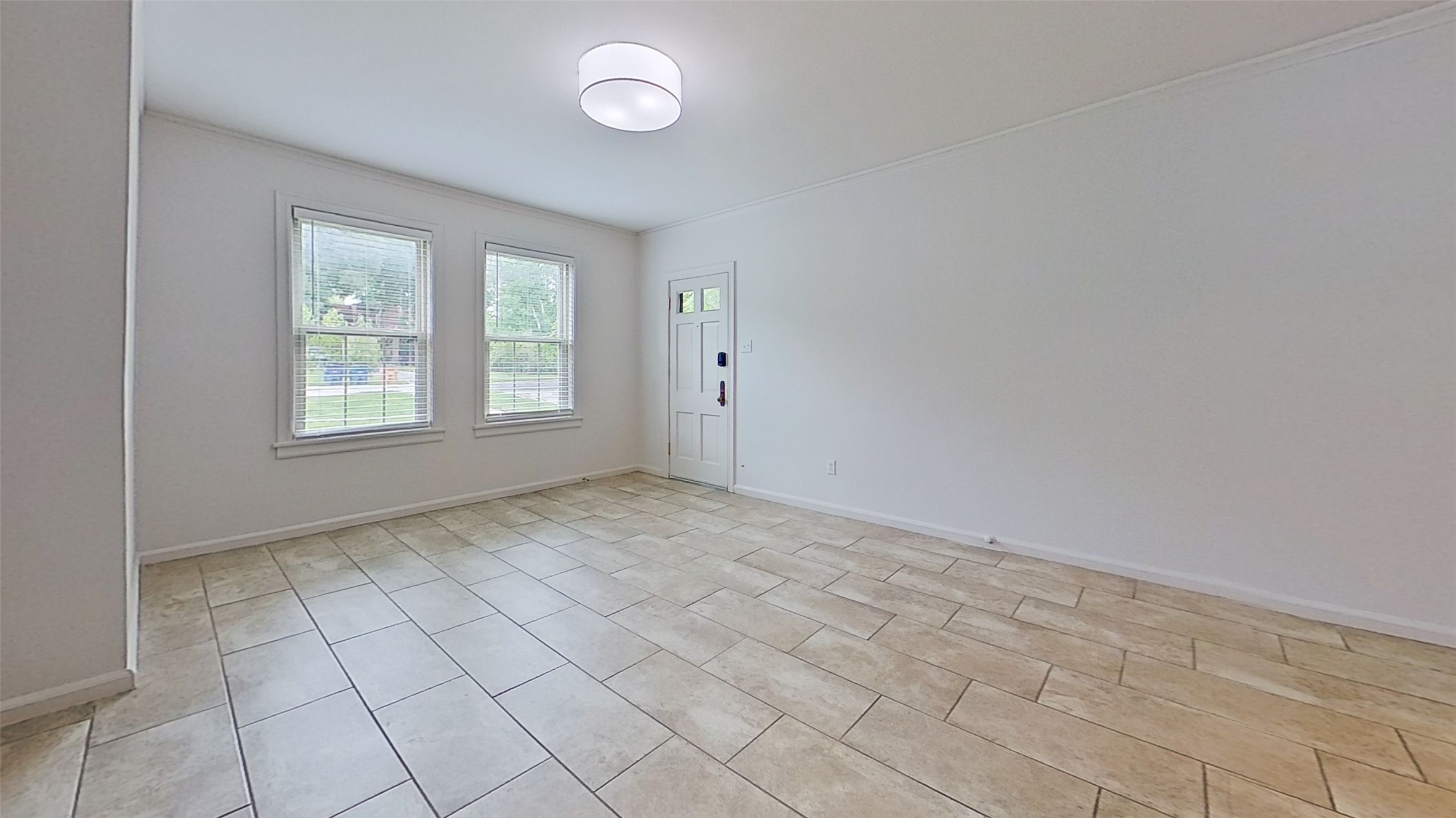 1703 Summit View Place, Unit A Austin, TX 78703 - Photo 7 of 13 A well-lit entry or living space boasts durable tile flooring and natural illumination through multiple windows.