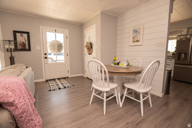 340 West 100 N Street Beaver, UT 84713 - Photo 9 of 37 Dining space with wood finished floors, crown molding, and wooden walls