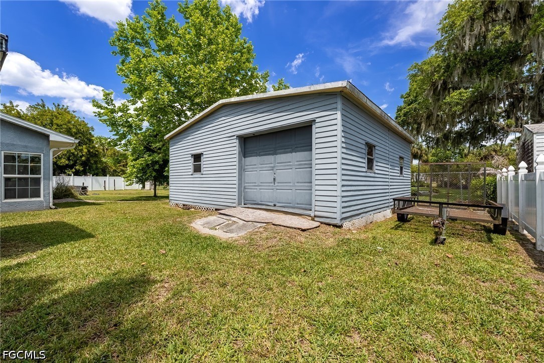 17290 Rewis Road Alva, FL 33920 - Photo 34 of 50 a backyard of a house with table and chairs