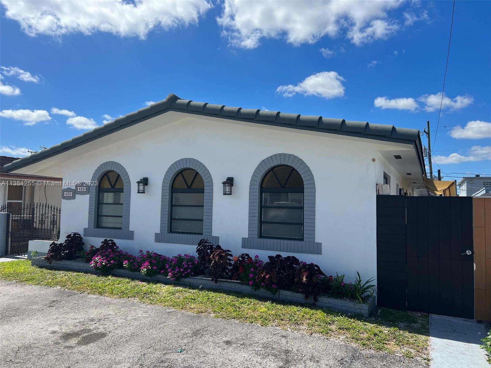 430 East 29th Street, Unit FRONT Hialeah, FL 33013 - Photo 1 of 17 a front view of a house with a yard