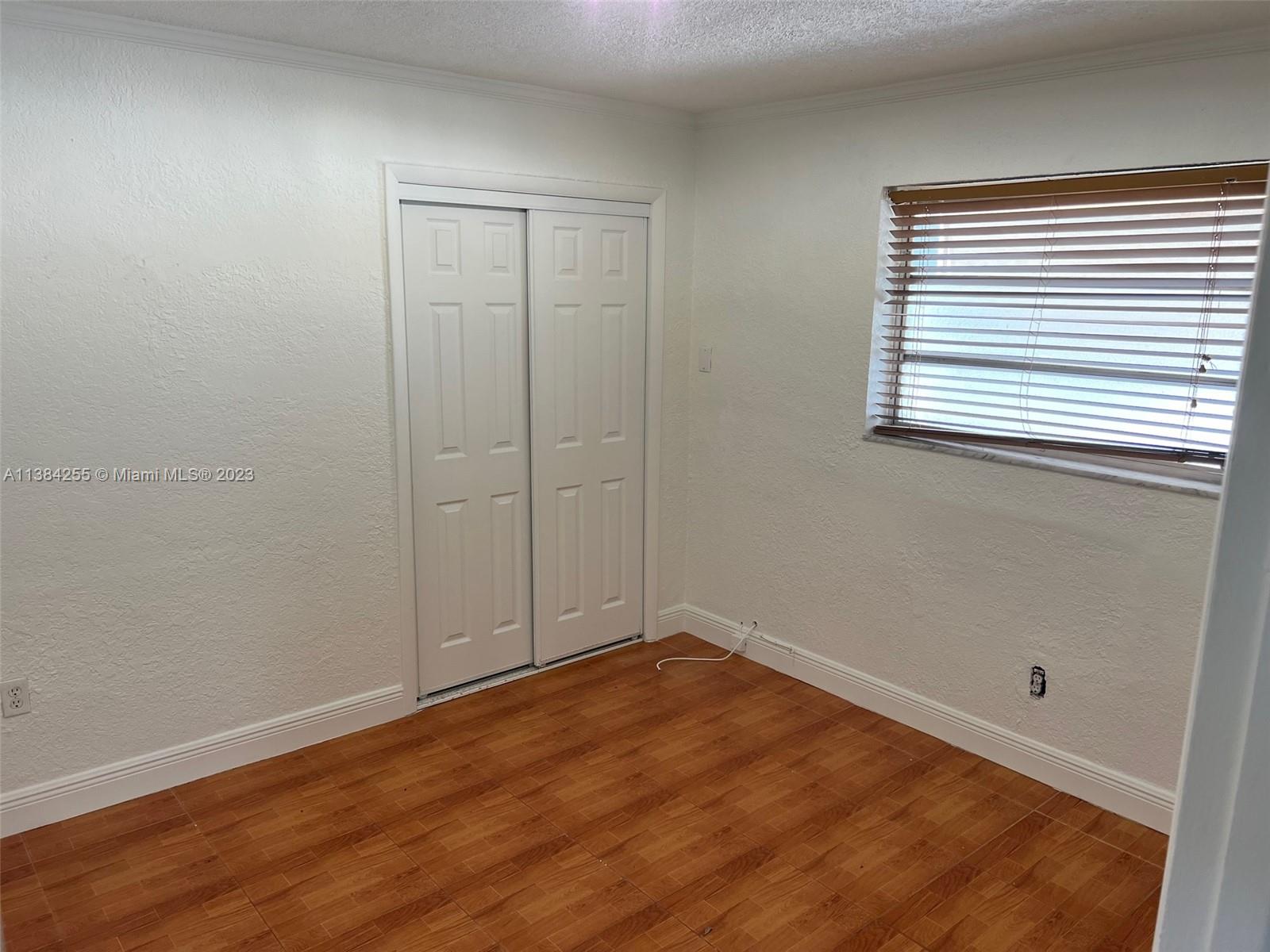430 East 29th Street, Unit FRONT Hialeah, FL 33013 - Photo 13 of 17 wooden floor in an empty room