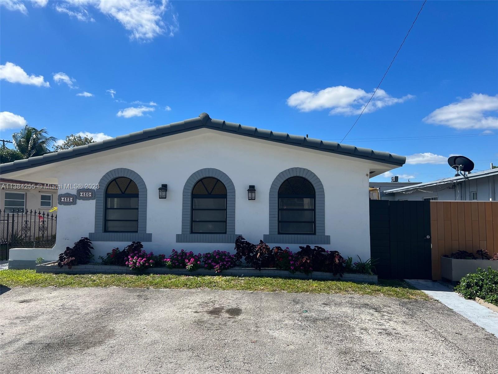 430 East 29th Street, Unit FRONT Hialeah, FL 33013 - Photo 16 of 17 a front view of a house with garden