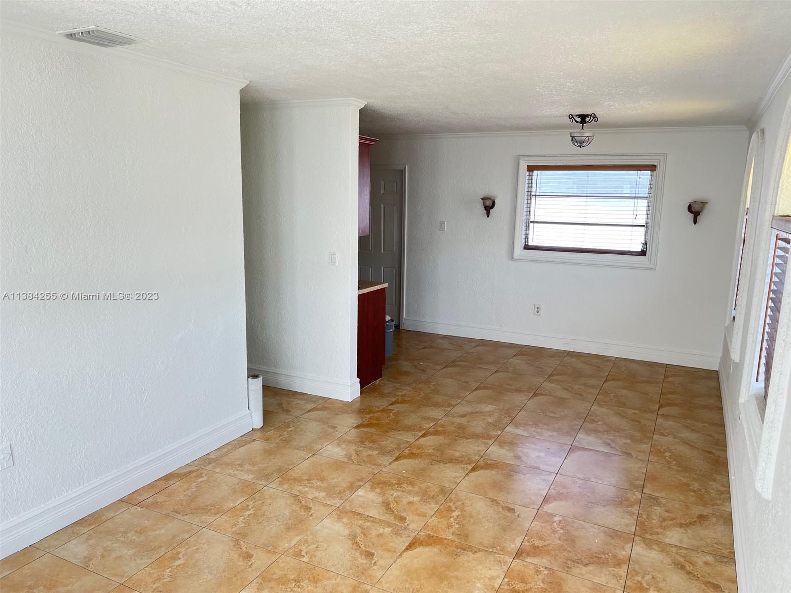 430 East 29th Street, Unit FRONT Hialeah, FL 33013 - Photo 4 of 17 an empty room with windows and closet