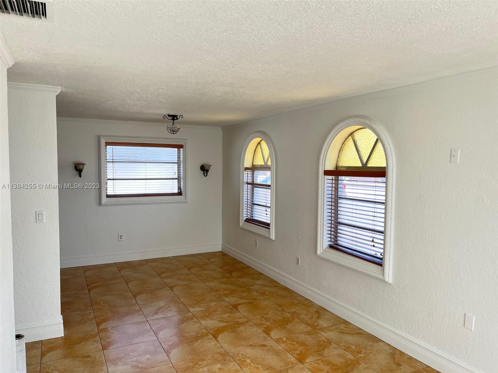 430 East 29th Street, Unit FRONT Hialeah, FL 33013 - Photo 5 of 17 an empty room with windows
