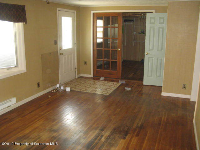 1040 Reservoir Road Moscow, PA 18444 - Photo 2 of 6 an empty room with wooden floor and windows