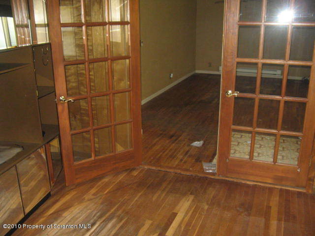 1040 Reservoir Road Moscow, PA 18444 - Photo 5 of 6 an empty room with wooden floor and windows