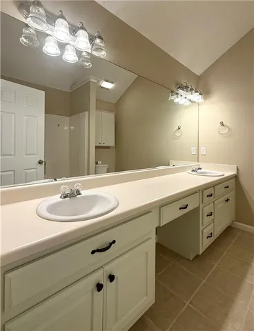 a bathroom with a double vanity sink and a mirror