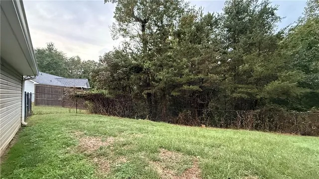 a backyard of a house with lots of green space