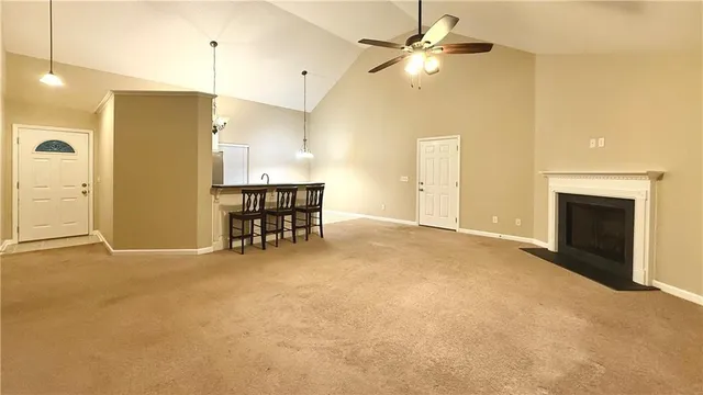 a view of a livingroom with furniture and a ceiling fan