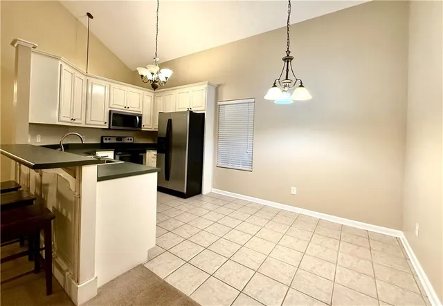 a kitchen with kitchen island a counter top space appliances and cabinets