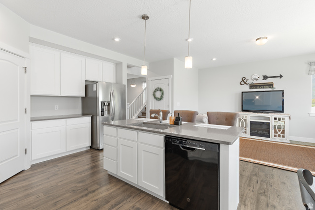 2343 Wysteria Drive Mapleton, UT 84664 - Photo 30 of 30 Kitchen featuring open floor plan, dishwasher, white cabinetry, pendant lighting, and stainless steel fridge